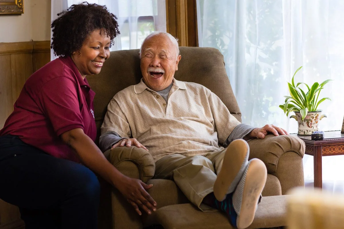 Caregiver having fun with elderly gentleman